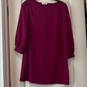 Plum dress with cuffed sleeves.